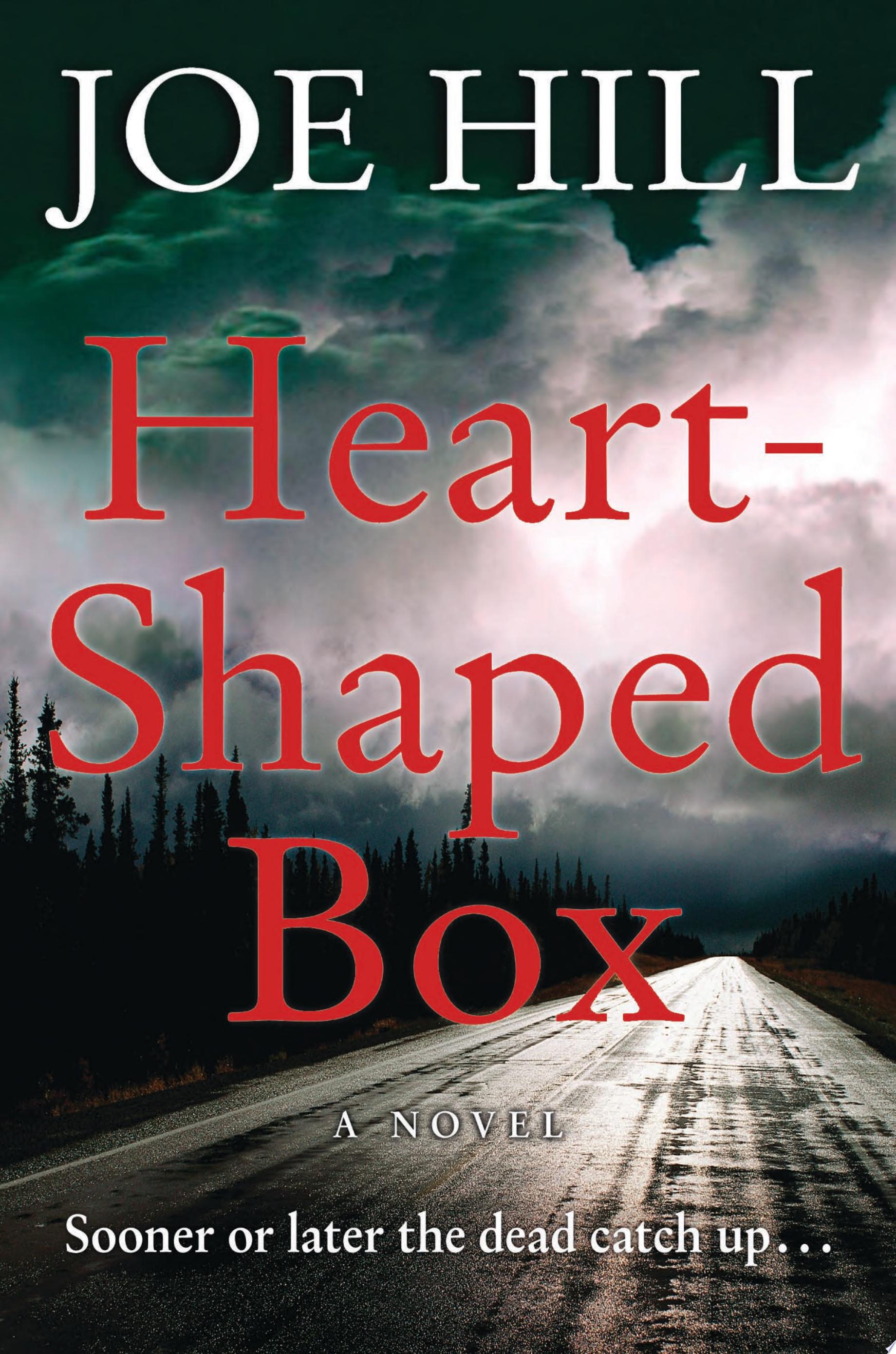 Cover for "Heart-Shaped Box" showing a long abandoned dark road in the woods