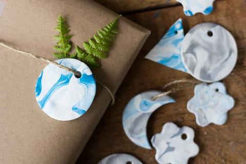 blue and white clay is swirled into the shape of a gift tag